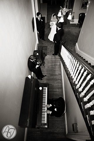 the bride and groom are walking down the stairs at their wedding ceremony in black and white