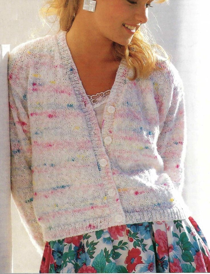 a woman wearing a flowered dress and cardigan