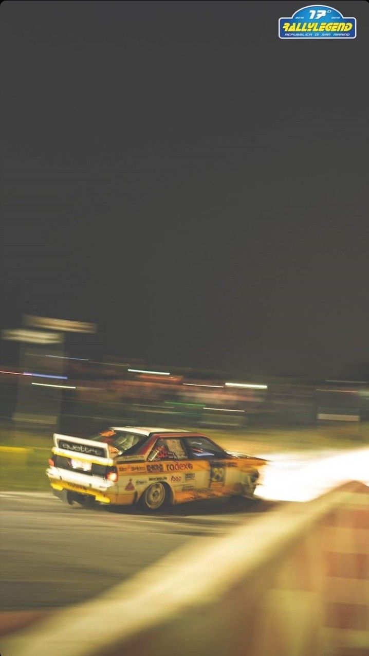 a car driving down a race track at night