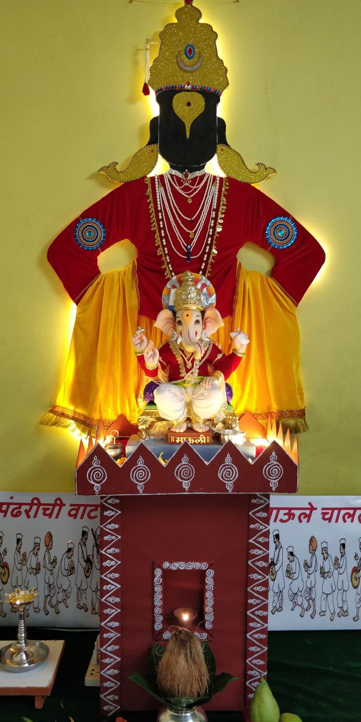 an idol is displayed in front of a yellow wall