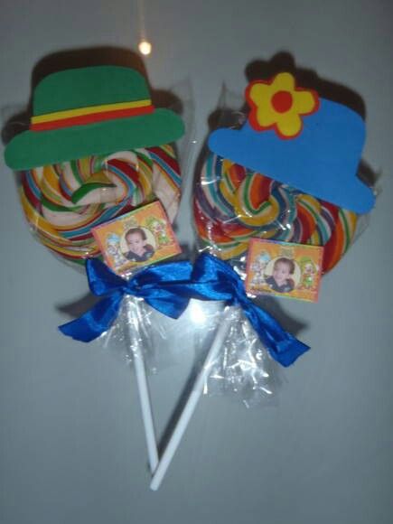 two lollipops with hats on them