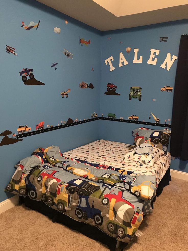 a child's bedroom with blue walls and toys on the bed