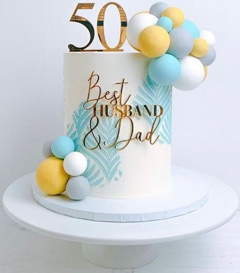 a 50th birthday cake with balloons and the number 50 on it