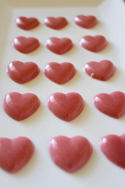 there are many heart shaped cookies on the table