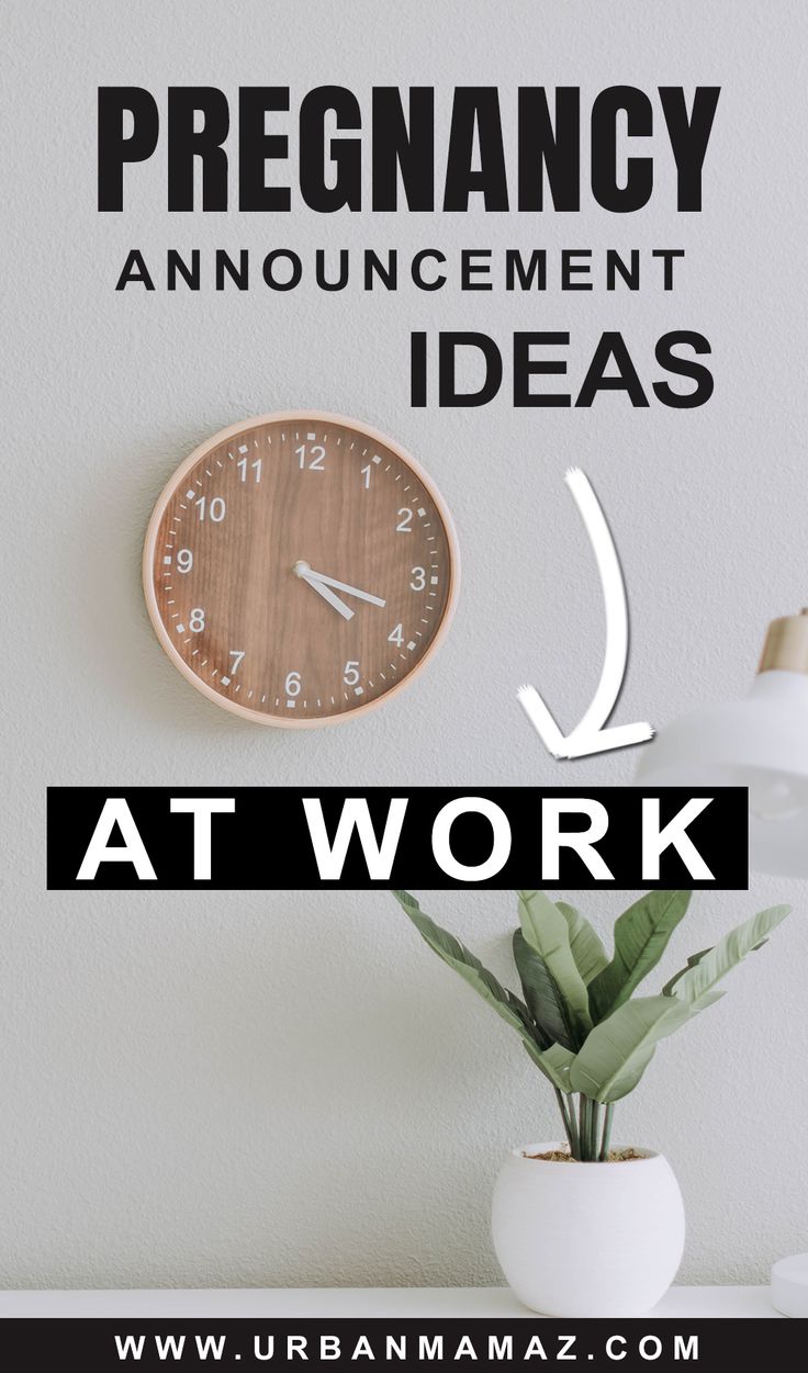 a clock sitting on top of a table next to a plant