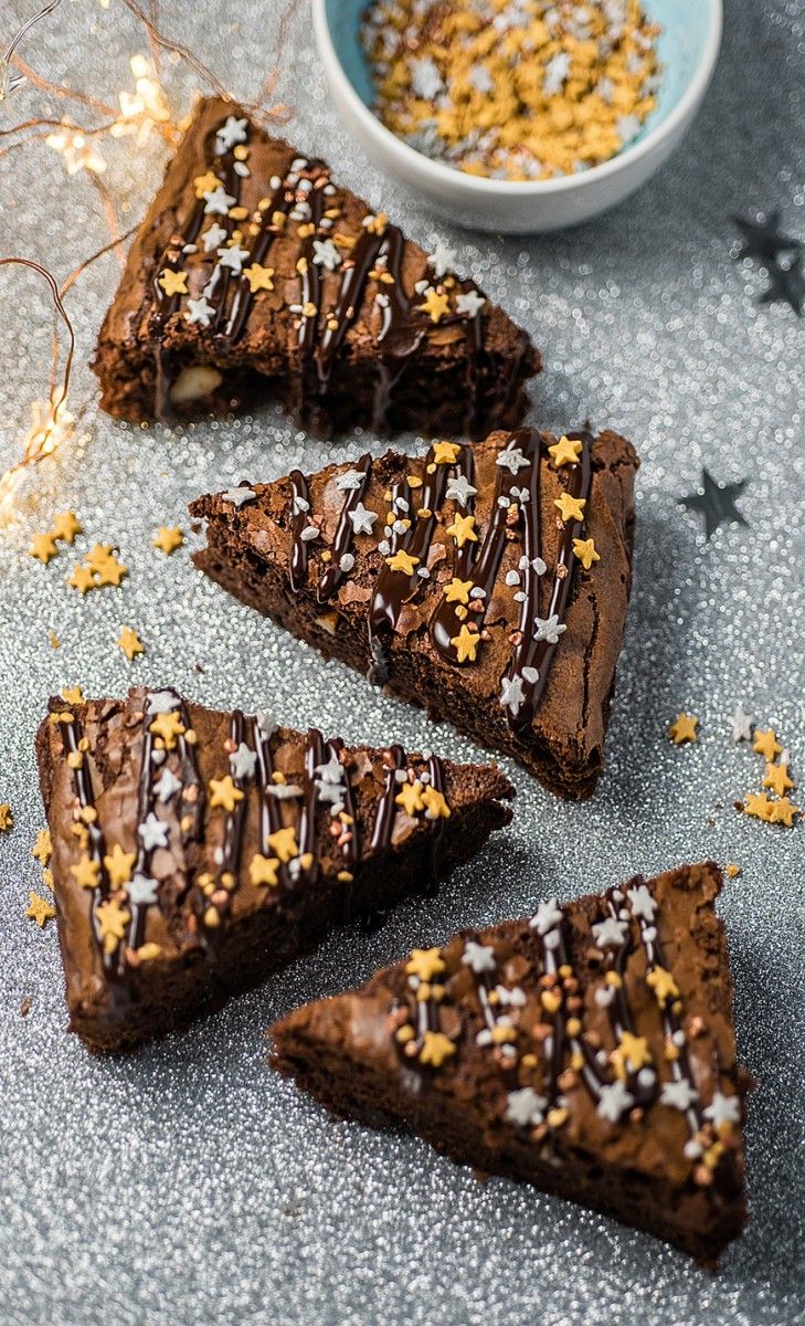 four pieces of chocolate cake with sprinkles on top and one slice missing