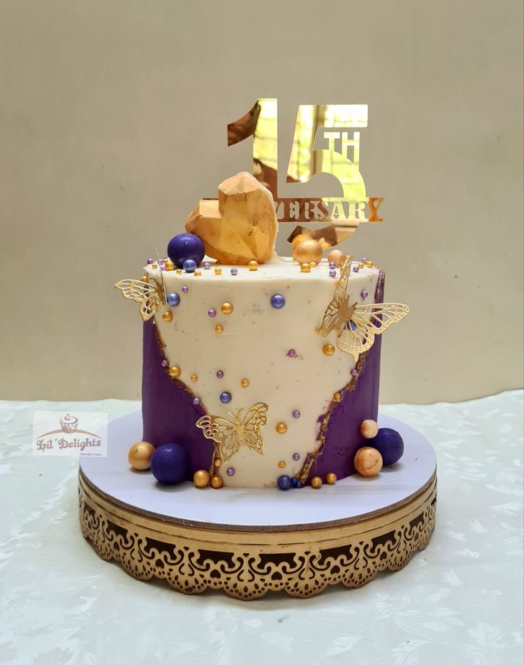 a birthday cake with gold and purple decorations