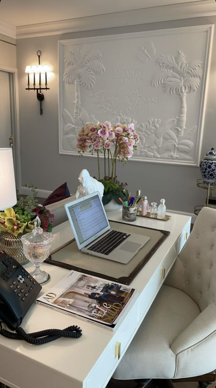 a laptop computer sitting on top of a white desk