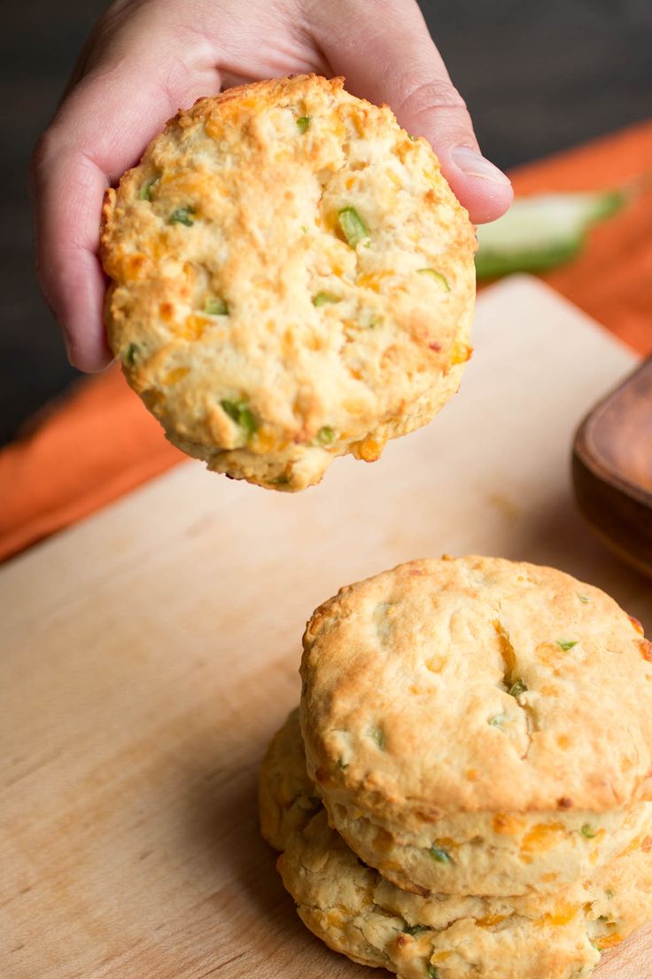 a person holding a biscuit in their right hand and another one on the other