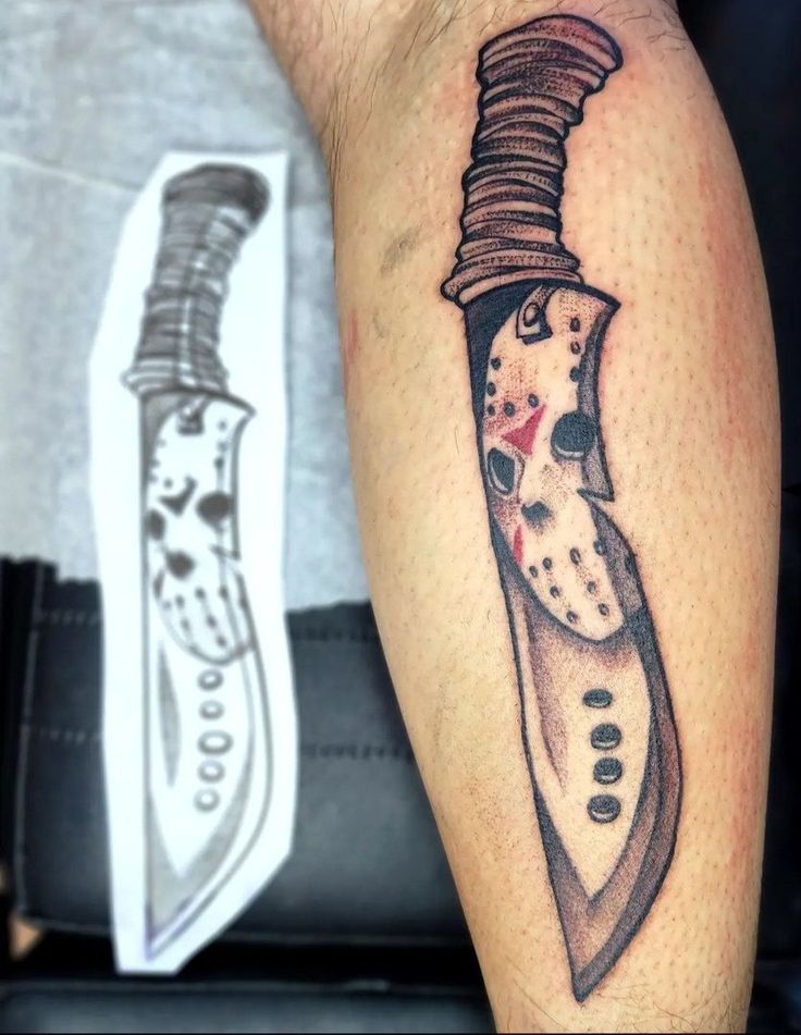 a tattoo on the arm of a man with a knife in it's head