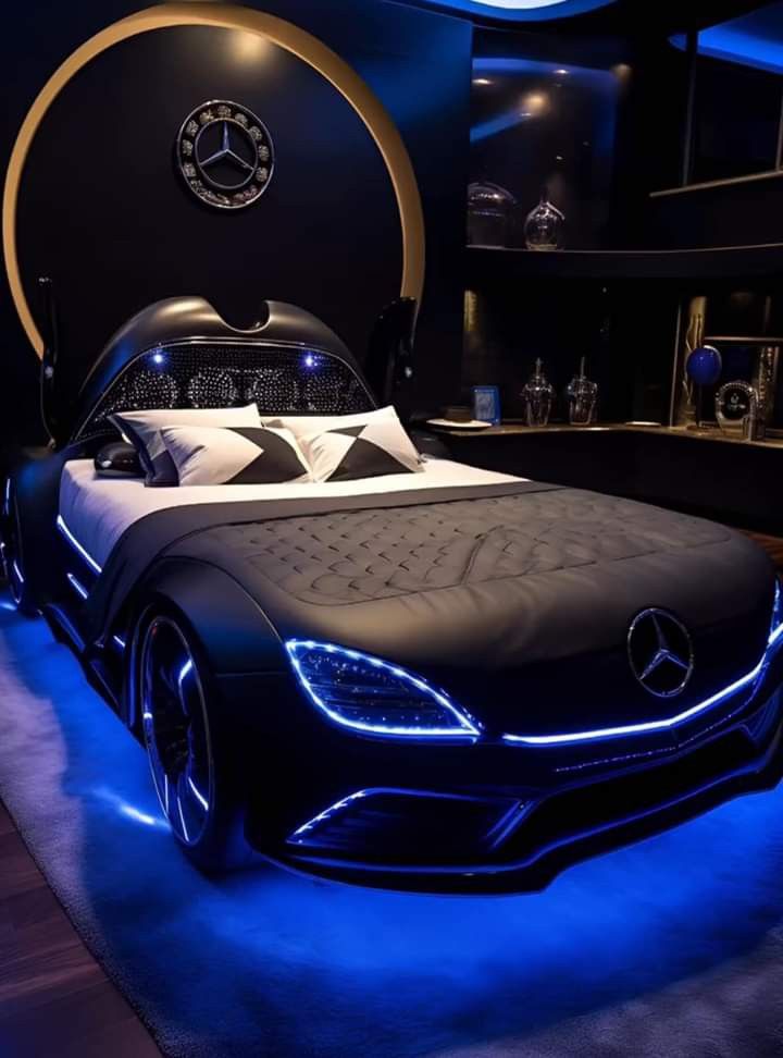 a bed that is in the middle of a room with blue lights on top of it