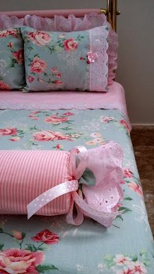 a bed with pink and blue flowers on it