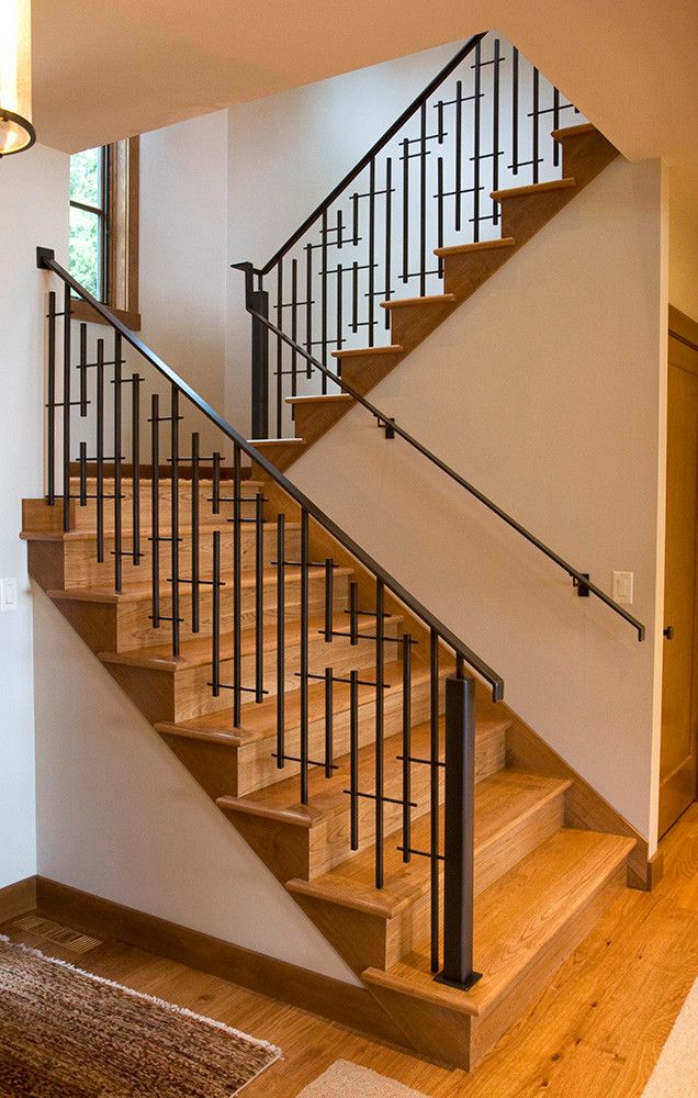 a wooden staircase with metal handrails in a home