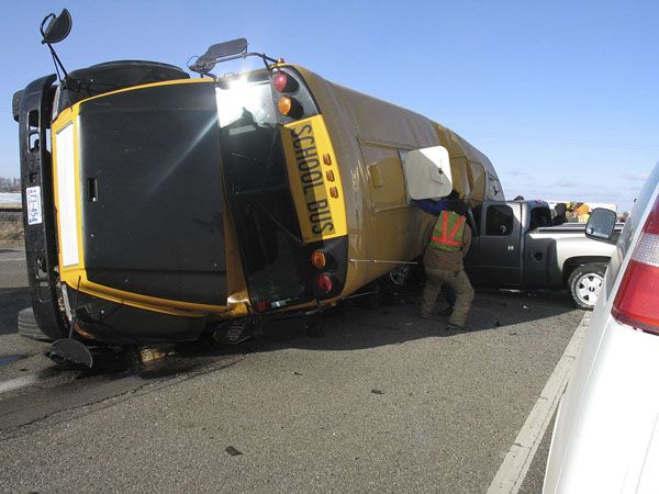 a man standing next to a yellow and black truck