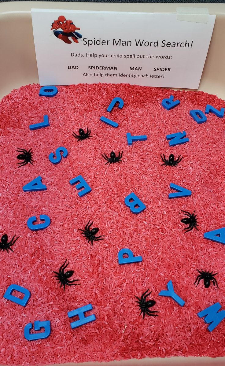 a spider man word search cake with blue letters and black widowes on it's red frosting