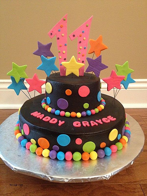 a birthday cake decorated with stars and confetti