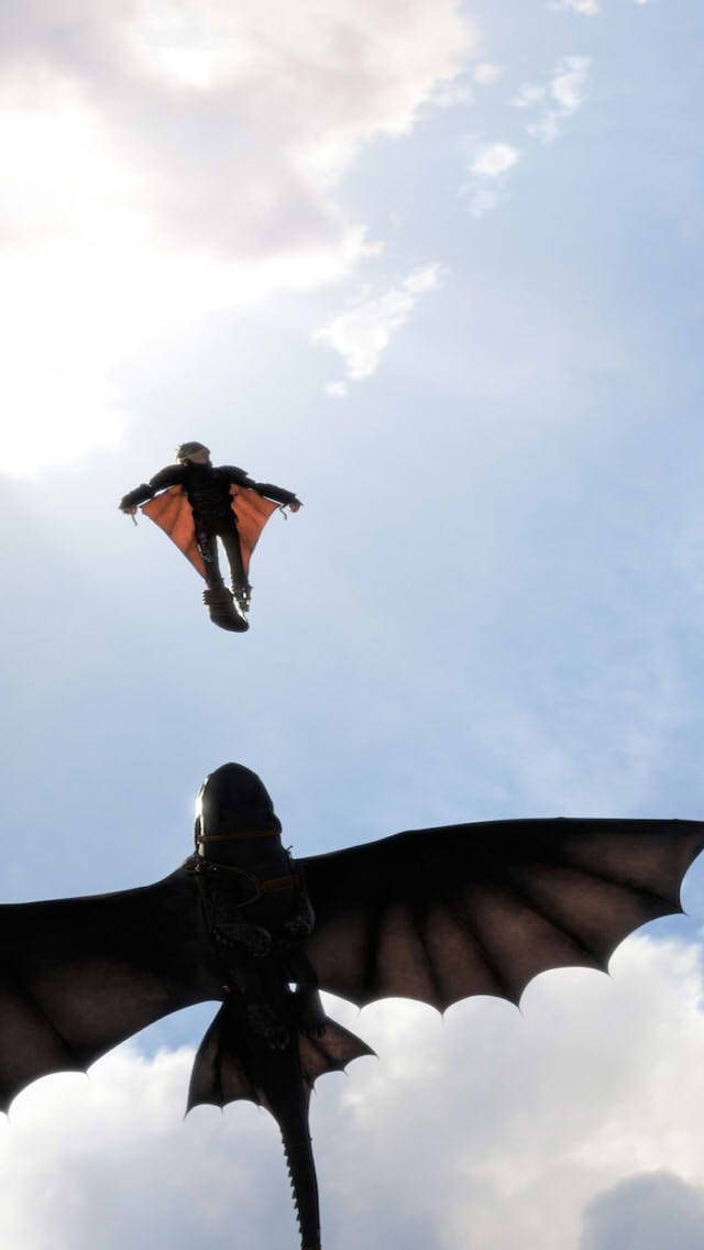 a man flying through the air while riding a dragon