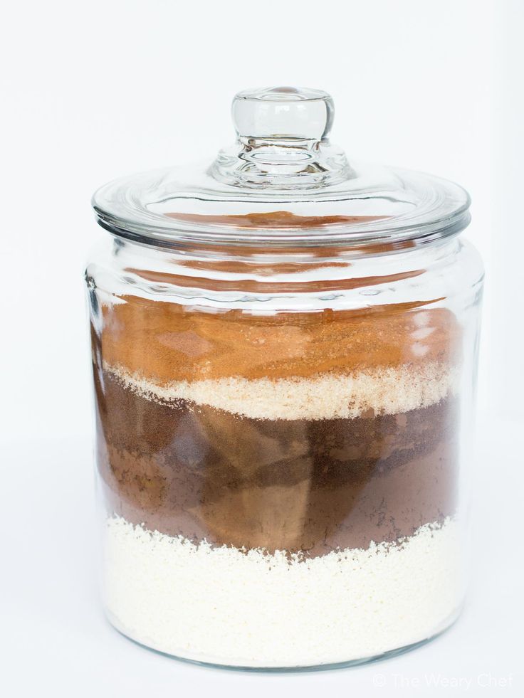 a glass jar filled with food on top of a white table