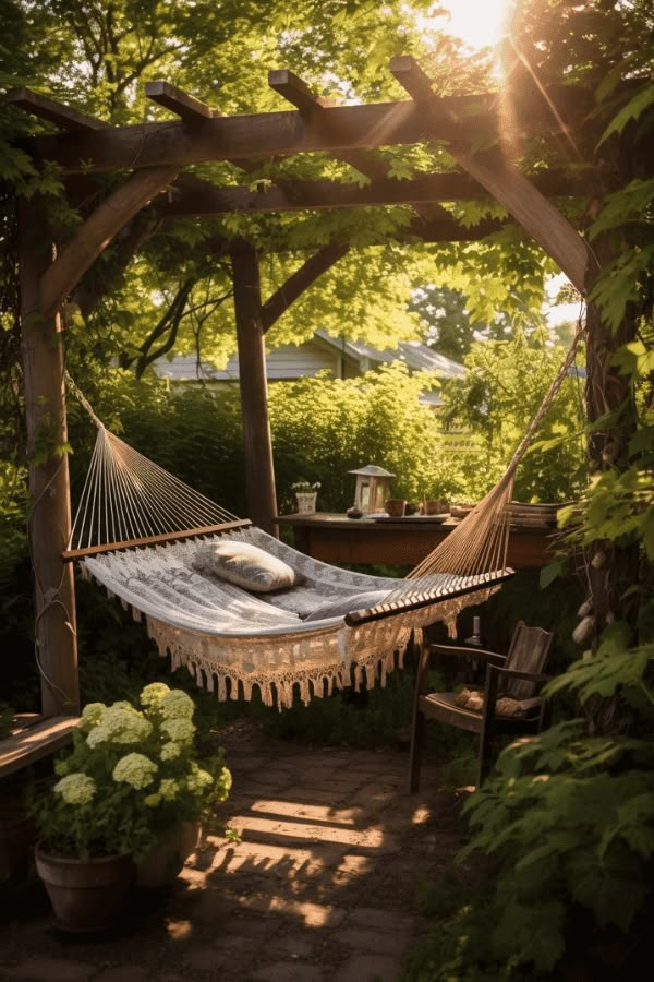 a hammock in the middle of a garden with sun shining through trees and bushes