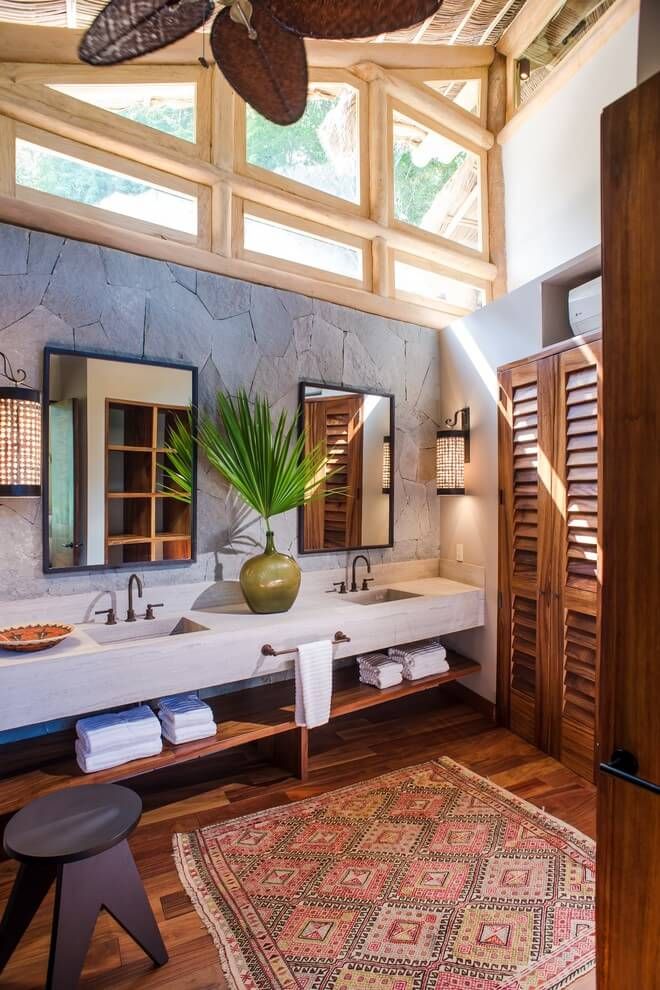 a bathroom with two sinks and a large rug on the floor in front of it