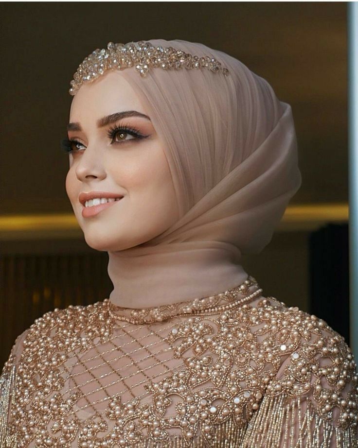 an image of a woman wearing a hijab with pearls on it's head