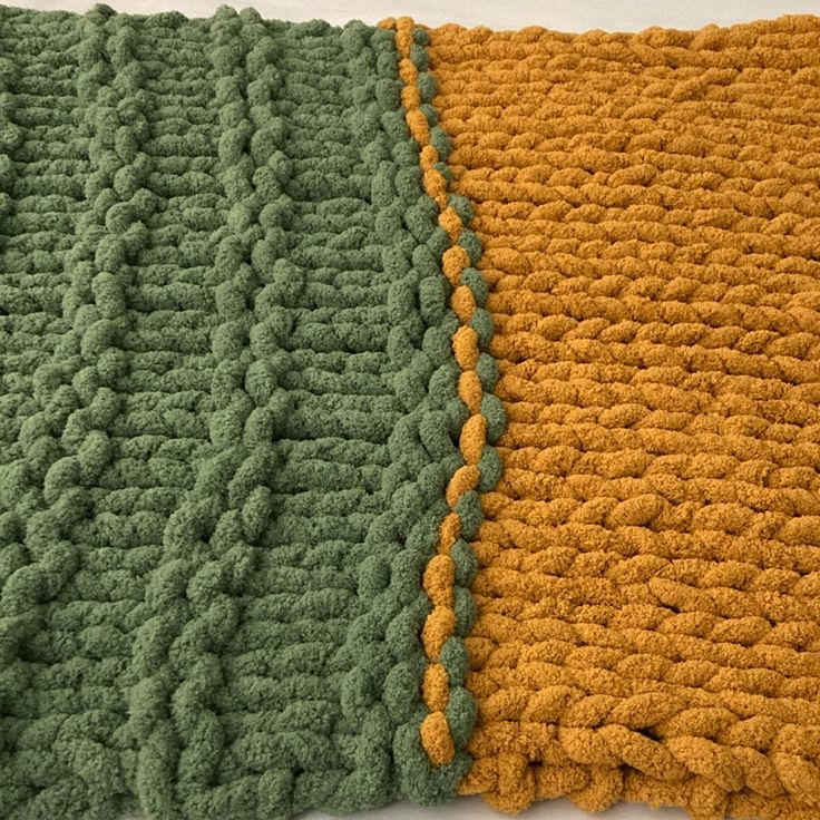 two crocheted blankets sitting on top of each other