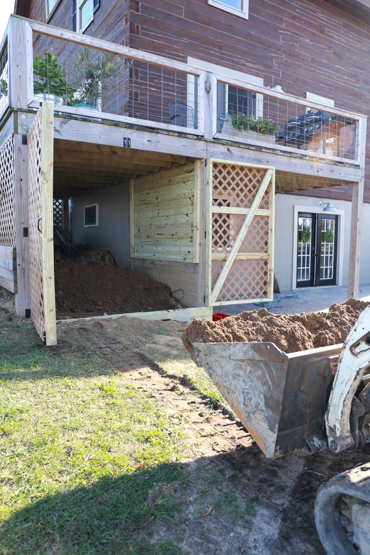 a large wheelbarrow sitting in front of a house