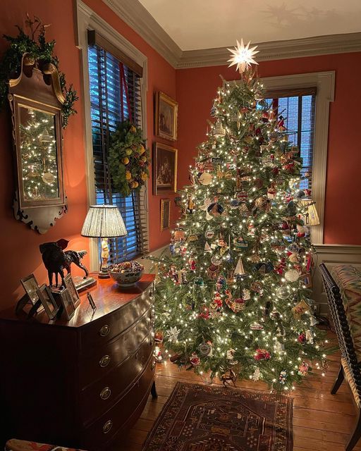 a decorated christmas tree in the corner of a room