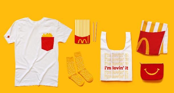 mcdonald's clothing and accessories are laid out on a yellow background, including a t - shirt