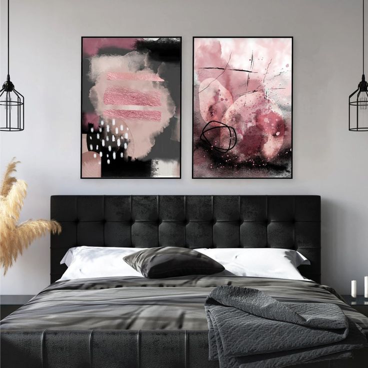 two paintings on the wall above a bed in a room with white walls and black furniture