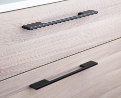 a close up of a drawer with handles on it