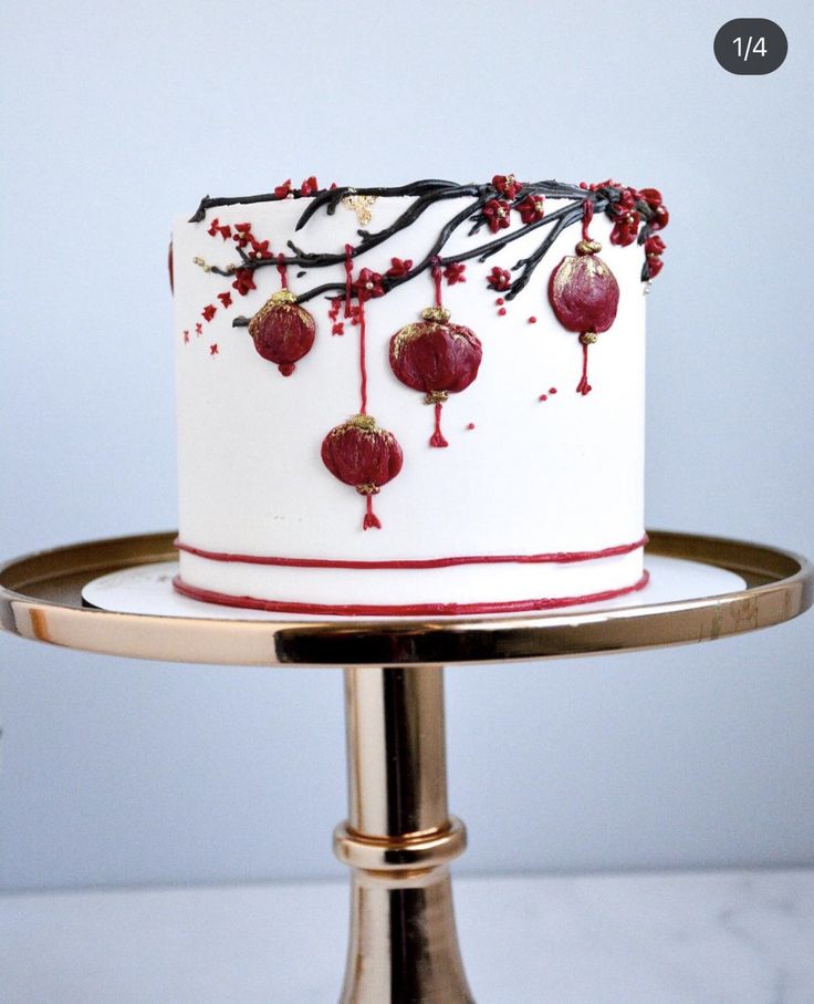 a white cake with red decorations on it