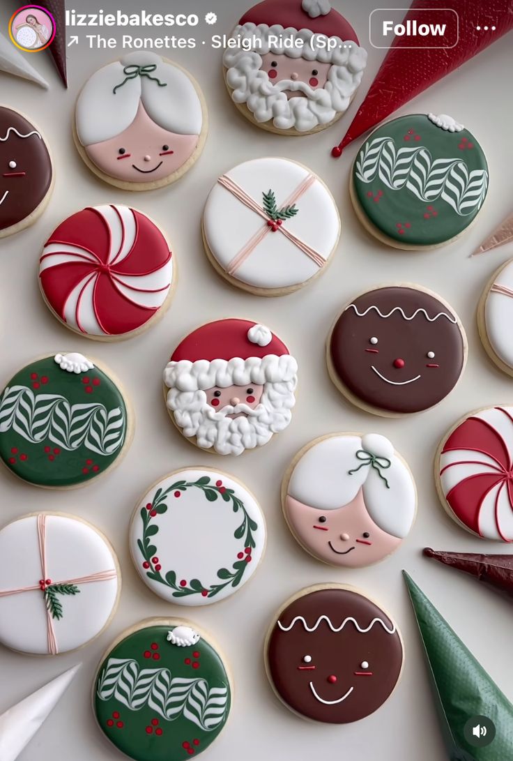 decorated cookies are arranged on a white surface