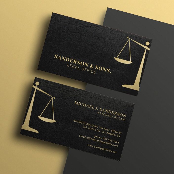 two black and gold business cards with an image of a balance scale on one side