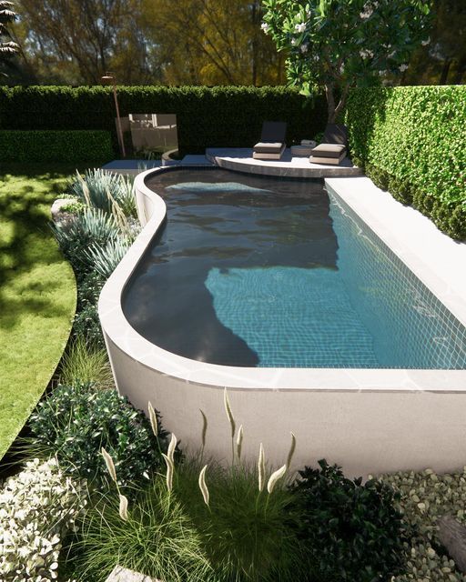 an outdoor swimming pool surrounded by greenery