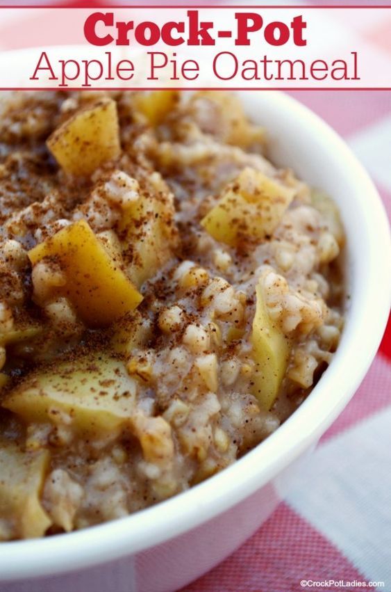 a bowl of oatmeal with apples and cinnamon in it on a checkered table cloth