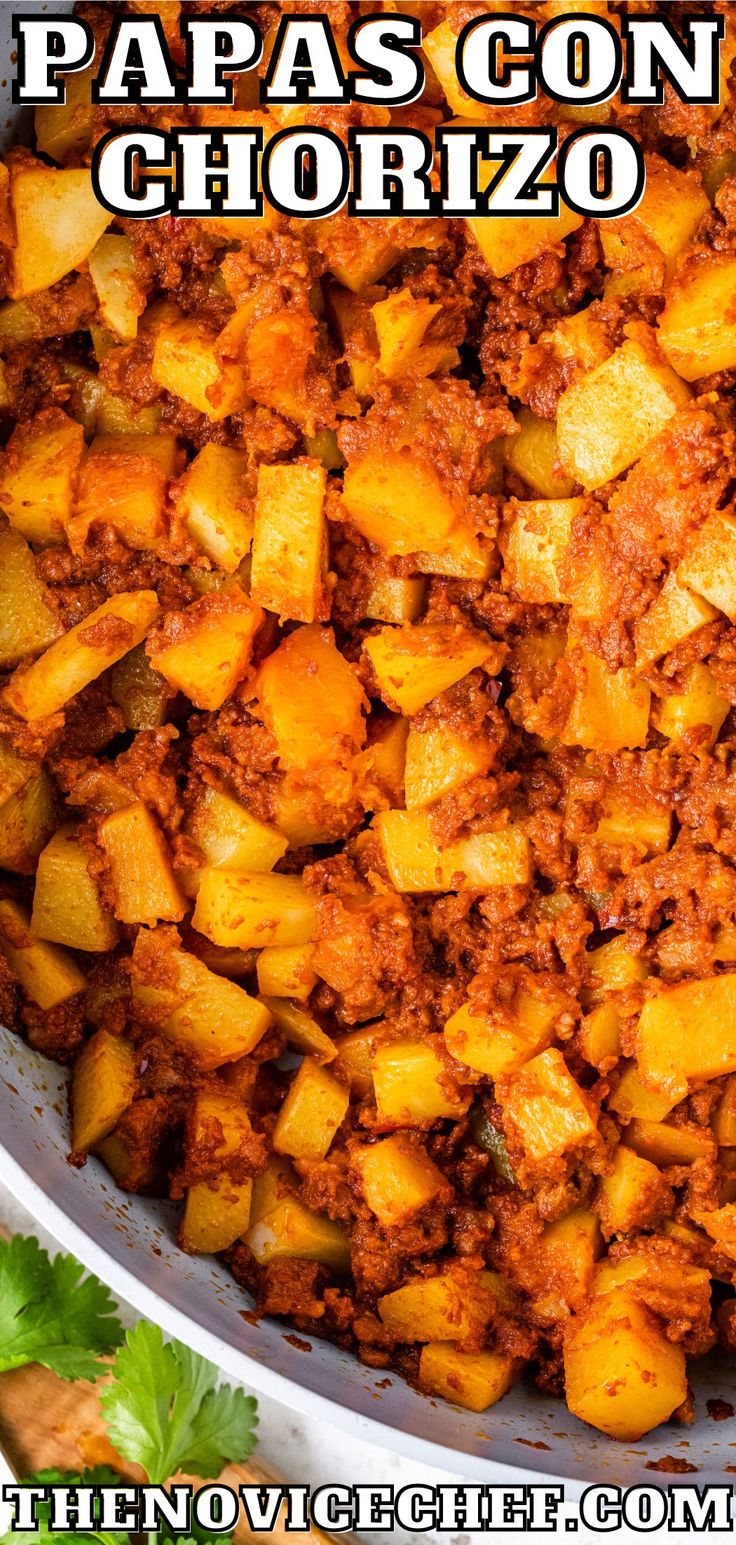 a close up of food in a pan with the words papas con chorizzo