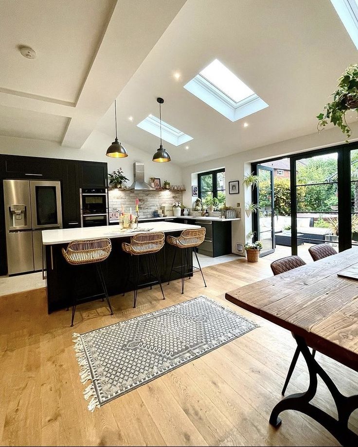 an open kitchen and dining room with skylights