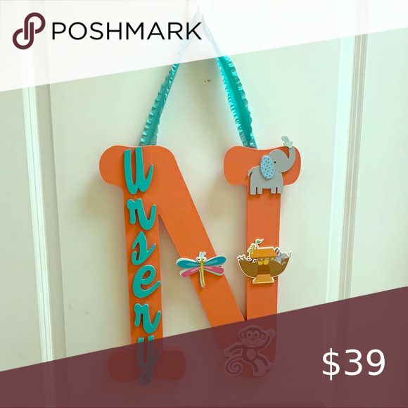 a door hanger with an elephant and giraffe design on it for $ 39