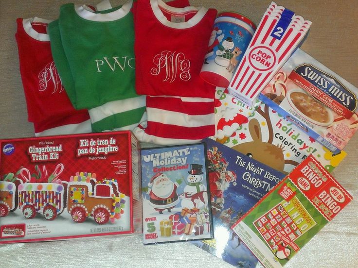 various children's clothing and books laid out on a bed