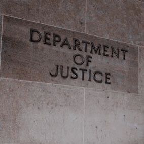 the department of justice sign on the side of a building