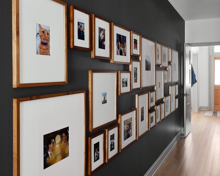 a wall with many pictures hanging on it