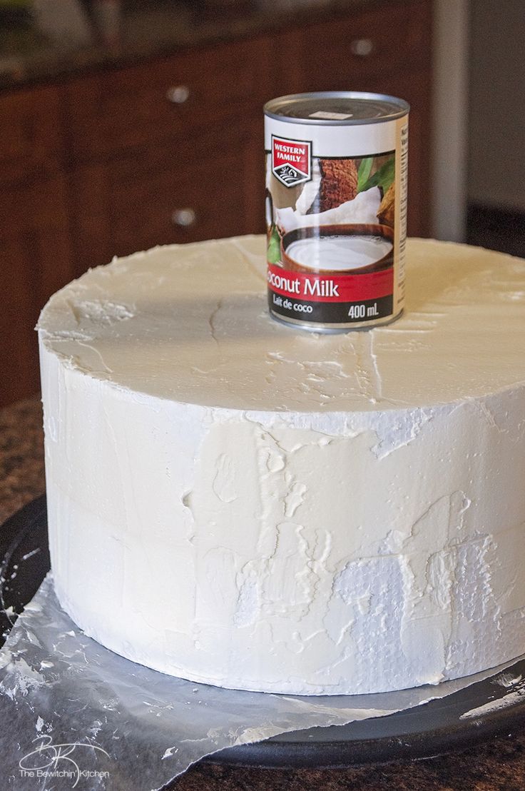 a can of coconut milk on top of a cake