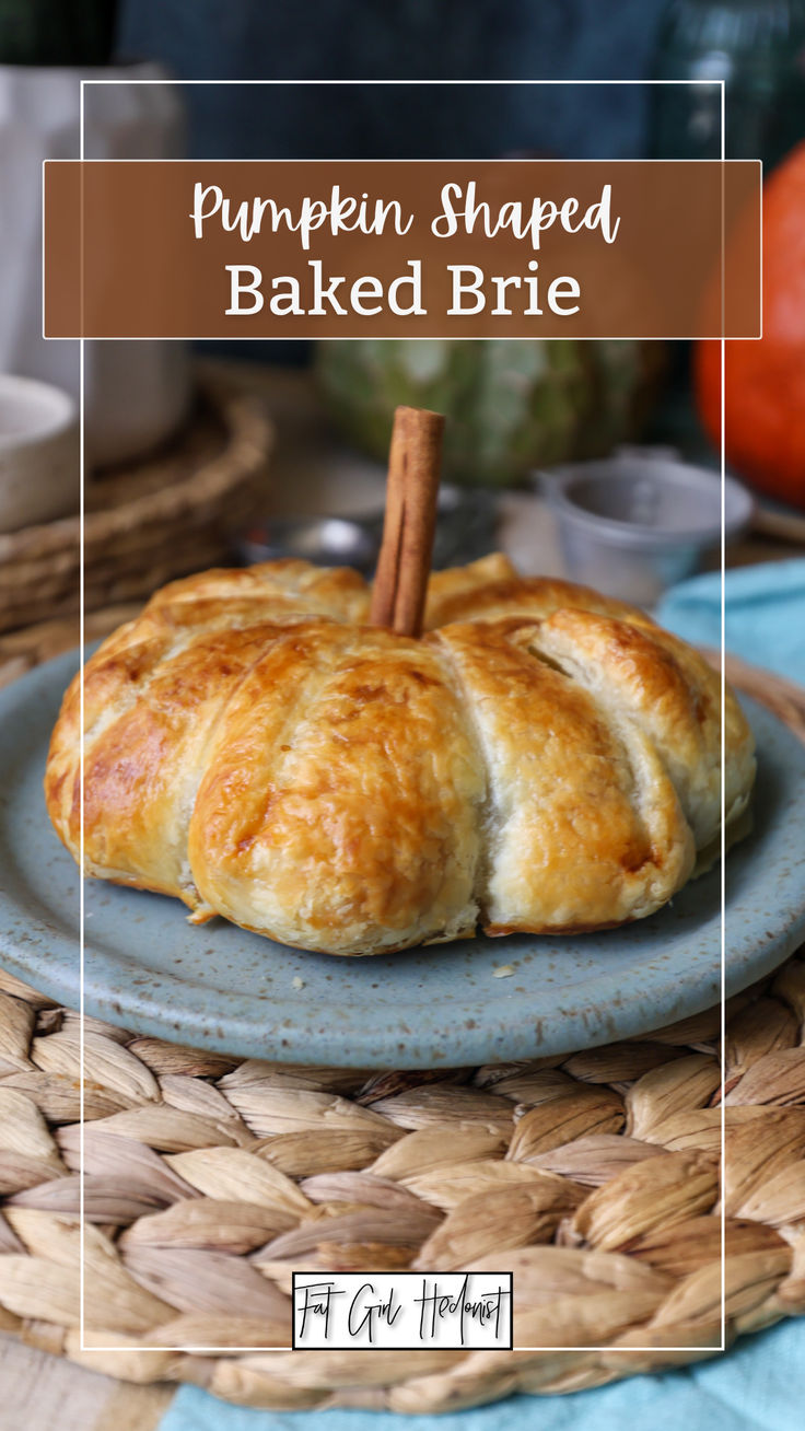 pumpkin shaped baked brie on a blue plate