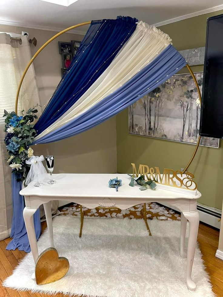 a white table topped with a blue and white drape