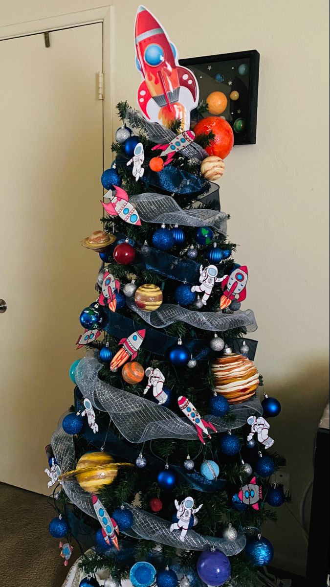 a christmas tree decorated with space themed ornaments