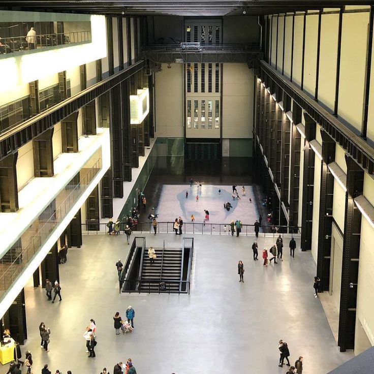 an overhead view of people walking around in a large building with many windows and balconies