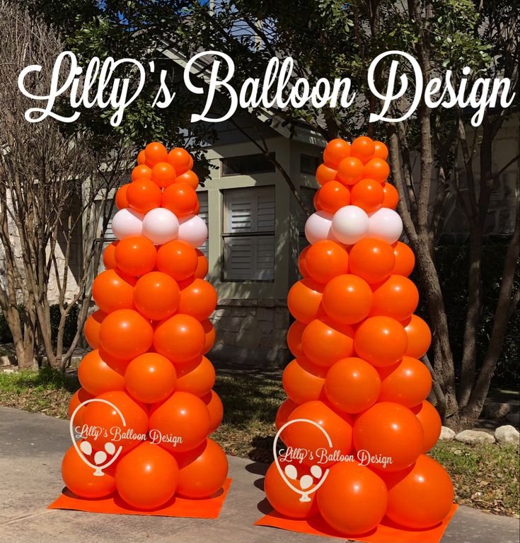 two tall orange and white balloons on top of each other