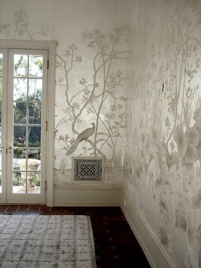 an image of a room with wallpaper on the walls and a door in the background