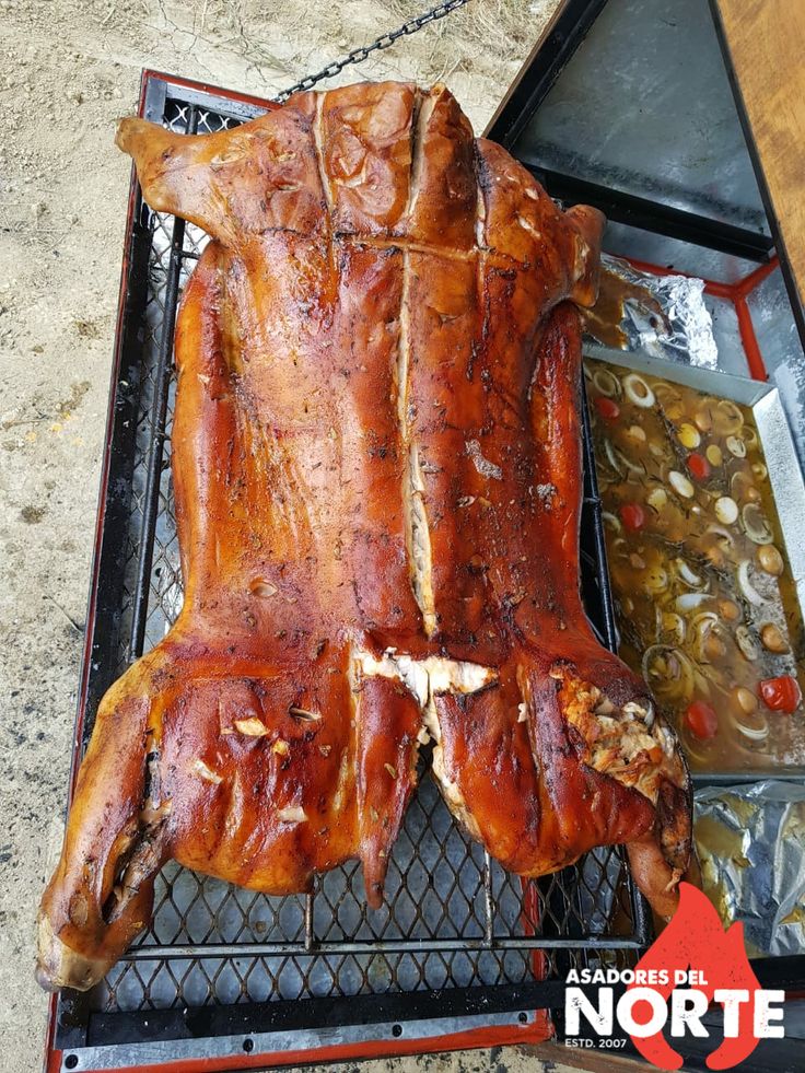 a large piece of meat sitting on top of a grill